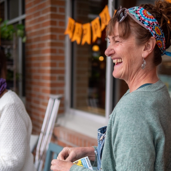 Board Director Cathy-Ann, giving away sunflower seeds on Earth Day.