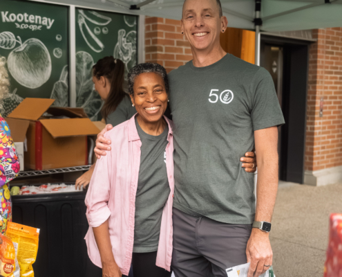 Kay and Paul handing out goodies on the Co-op's 50th Birthday.