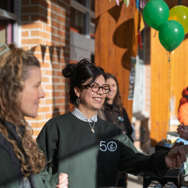 Jackie handing out hot apple cider on Member Appreciation Day.